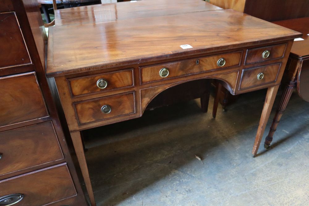A George III mahogany dressing table, with crossbanded and five small drawers, width 107cm